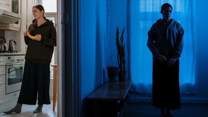 A woman with Bipolar Disorder shown in two settings—daylight in a kitchen and darkness in a room, symbolizing mood swings.