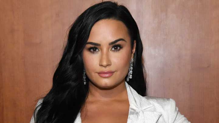 Demi Lovato posing confidently for the camera, highlighting her advocacy for Bipolar Disorder awareness.