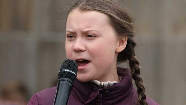 Greta Thunberg giving a passionate speech on climate action at a public event.