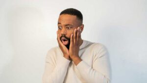 An African-American young man with a shocked expression on his face, symbolizing the intense fear and emotional impact of Panic Disorder.