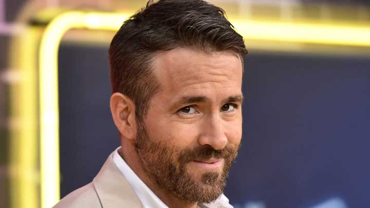 Ryan Reynolds smiling warmly at the camera, reflecting his openness about living with Generalized Anxiety Disorder.